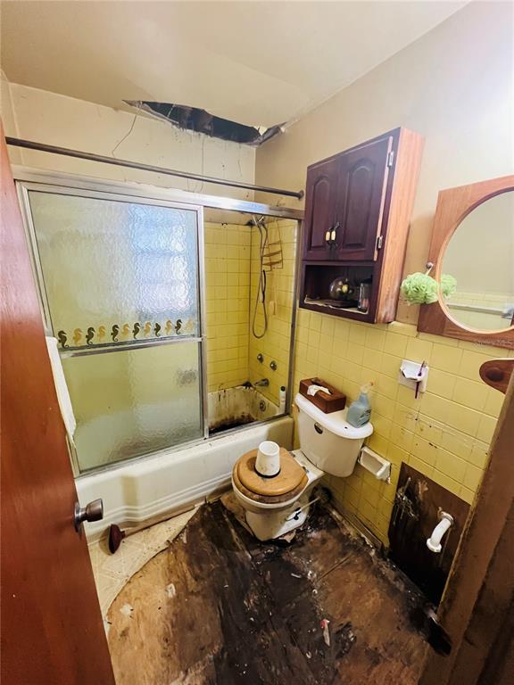 1004 Northeast 22nd Street Gainesville, FL 32641 - Photo 13 of 13 a bathroom with a granite countertop toilet sink and mirror