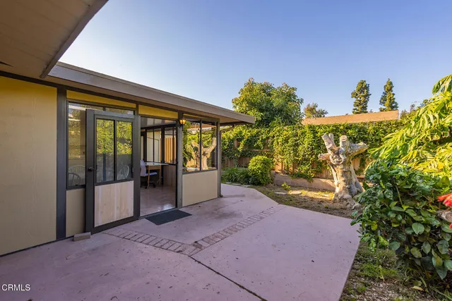 a view of building with glass door and porch