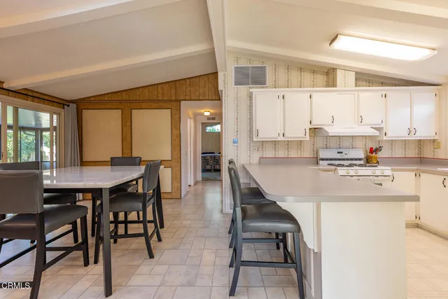 a kitchen with refrigerator and cabinets