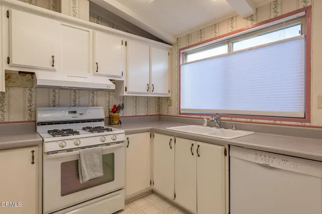 a view of a dining room with furniture and window