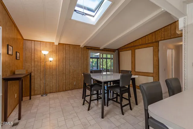 a spacious bedroom with a bed and a chandelier