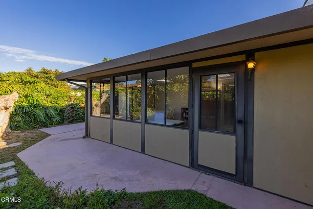 a swimming pool with an outdoor seating and yard