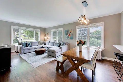 a view of a dining room with furniture window and wooden floor