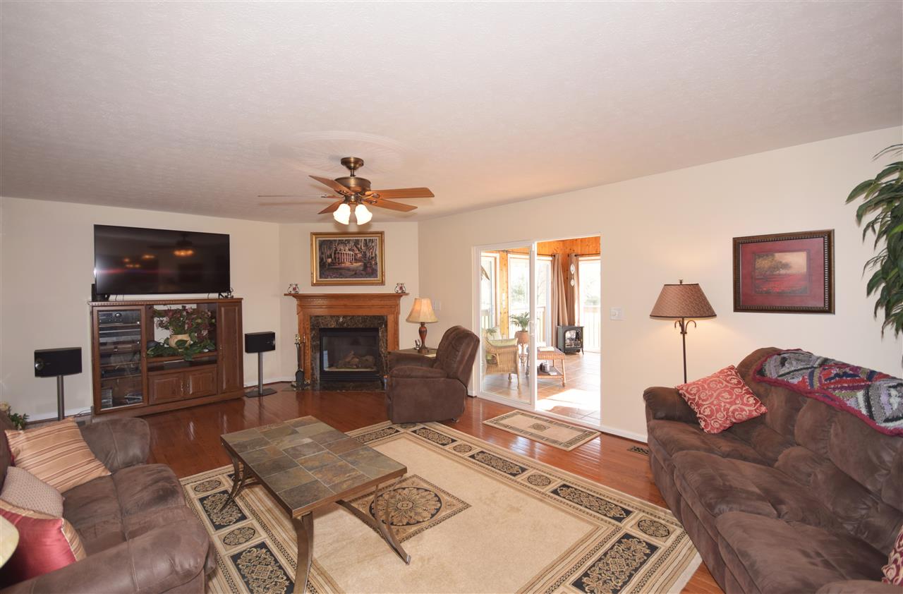 4613 Conicville Road Mount Jackson, VA 22842 - Photo 12 of 35 a living room with furniture a fireplace and a flat screen tv