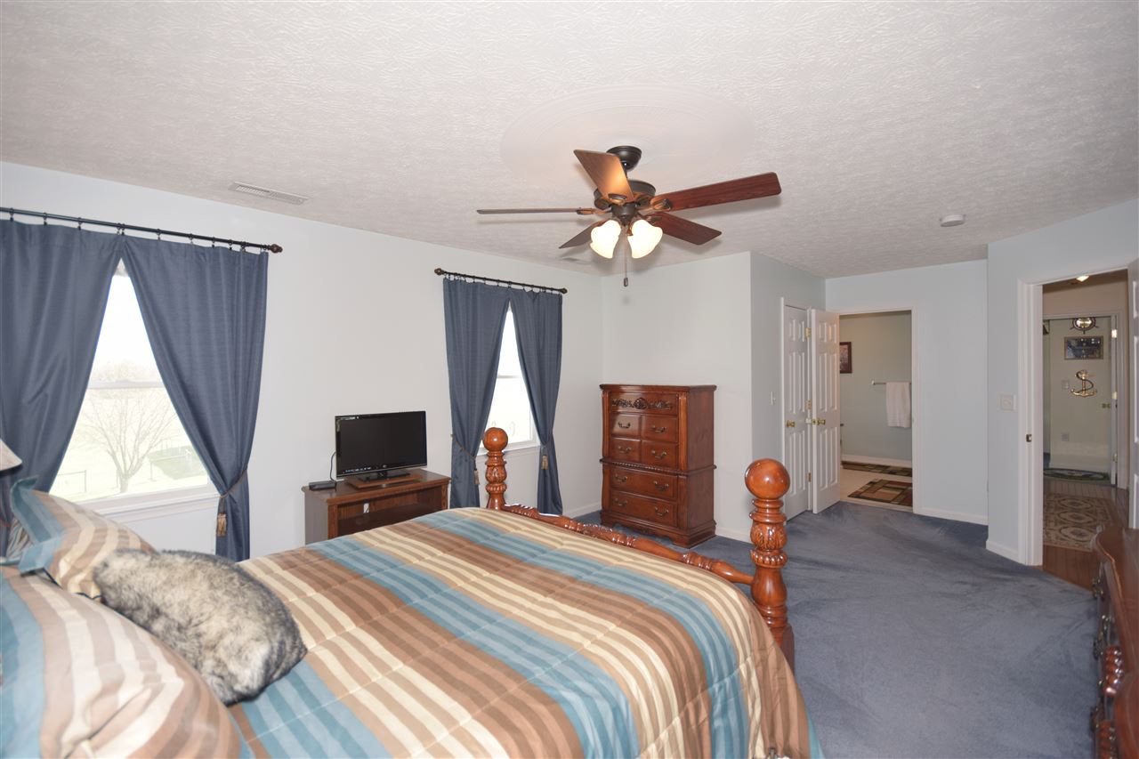 4613 Conicville Road Mount Jackson, VA 22842 - Photo 16 of 35 a bedroom with a bed and a chandelier
