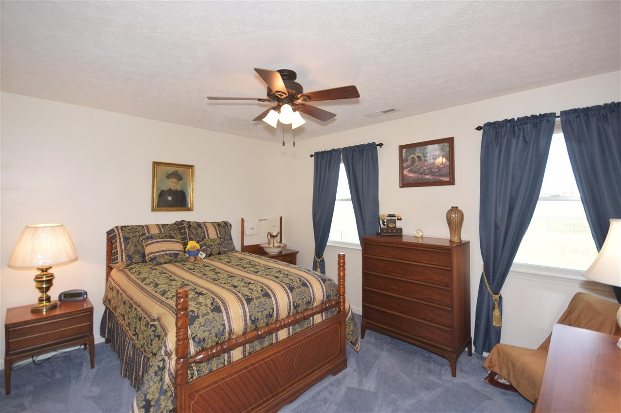 4613 Conicville Road Mount Jackson, VA 22842 - Photo 18 of 35 a bedroom with a bed and a chandelier