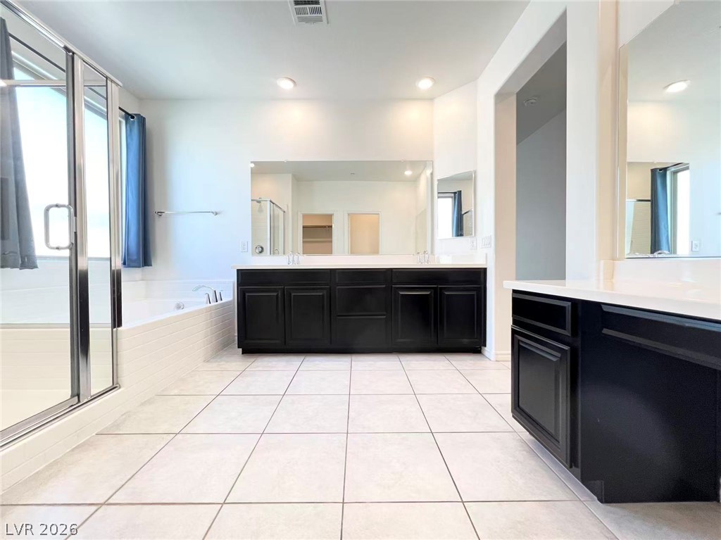 925 Bayberry Ridge Street Henderson, NV 89052 - Photo 17 of 27 A grand primary bath with a spacious shower, soaking tub, and double vanity provides a tranquil retreat.