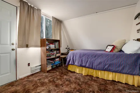 a living room with a couch and wooden floor