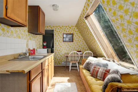 a kitchen with a sink and a stove next to a window