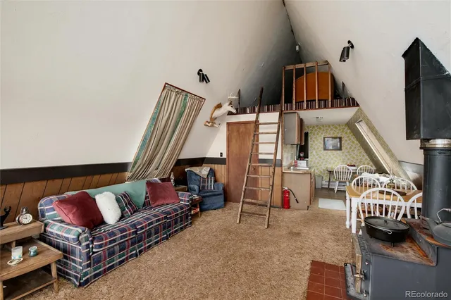 a living room with furniture a flat screen tv and floor to ceiling window