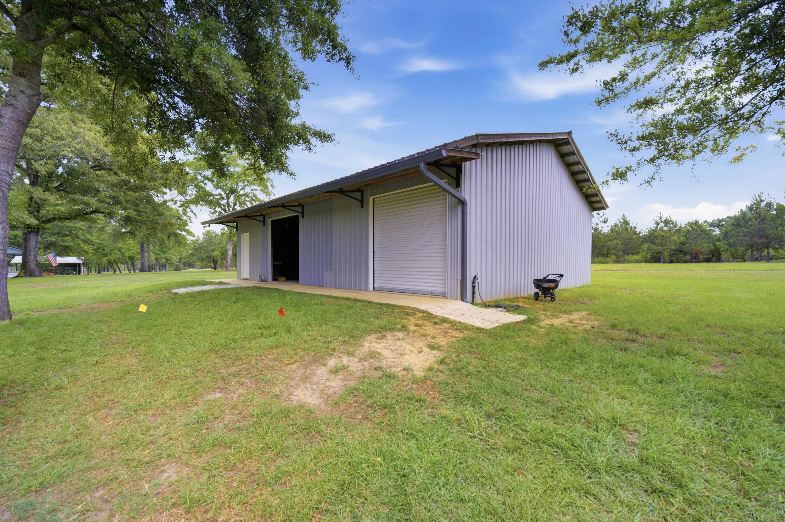 261 Wilkerson Road DeFuniak Springs, FL 32433 - Photo 74 of 76 a backyard of a house with lots of green space
