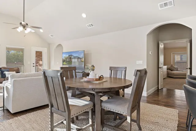 a view of a dining room with furniture and wooden floor