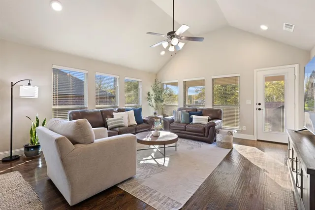 a living room with furniture and large windows