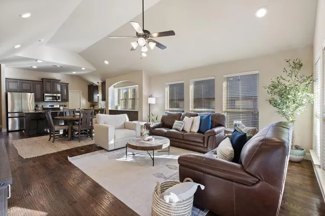 a living room with furniture and a chandelier
