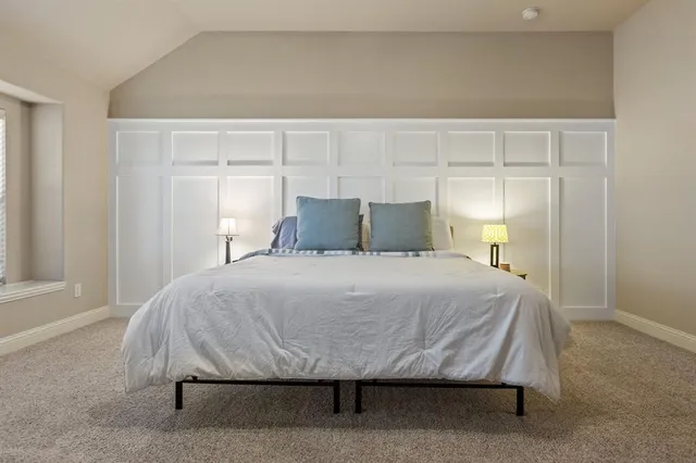 a bedroom with a bed and window
