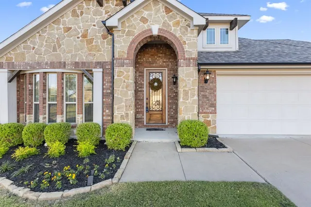 a view of a brick house with large windows
