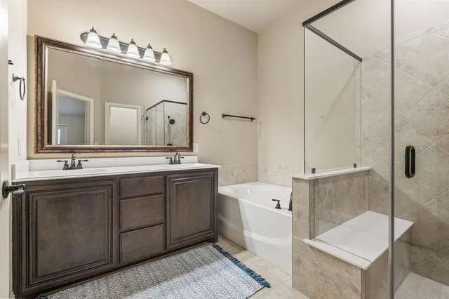 a bathroom with a double vanity sink mirror and toilet