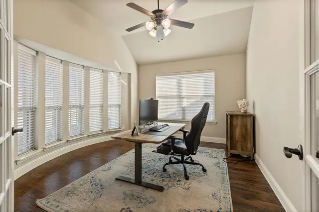 a view of a workspace with furniture and a window