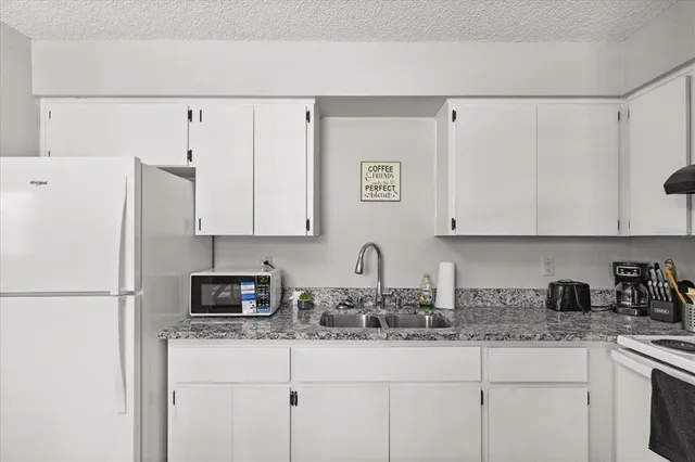 a spacious bedroom with a bed and a window