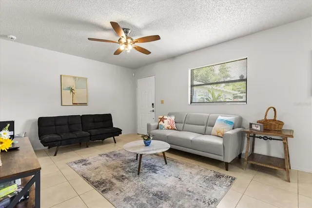 a living room with furniture and kitchen view