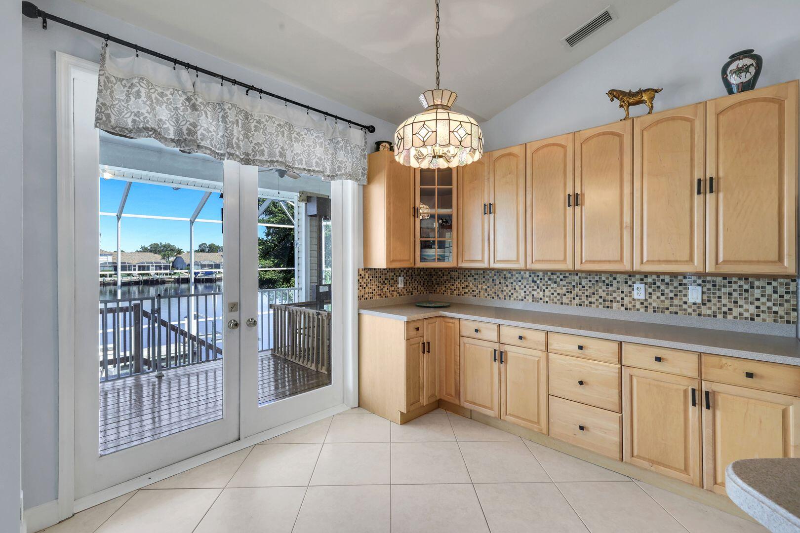 183 Sunset Cay Naples, FL 34114 - Photo 12 of 45 a view of a kitchen with a dishwasher cabinets and furniture