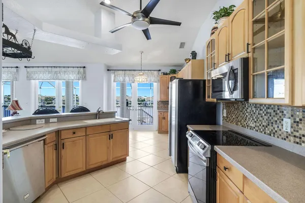 a kitchen with stainless steel appliances granite countertop a sink a stove and a refrigerator