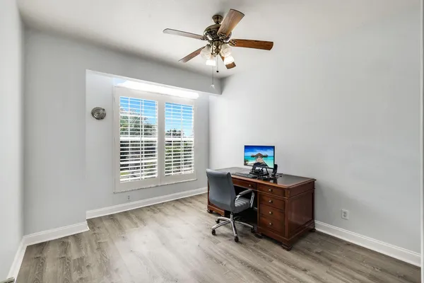 a view of a workspace with furniture and a window