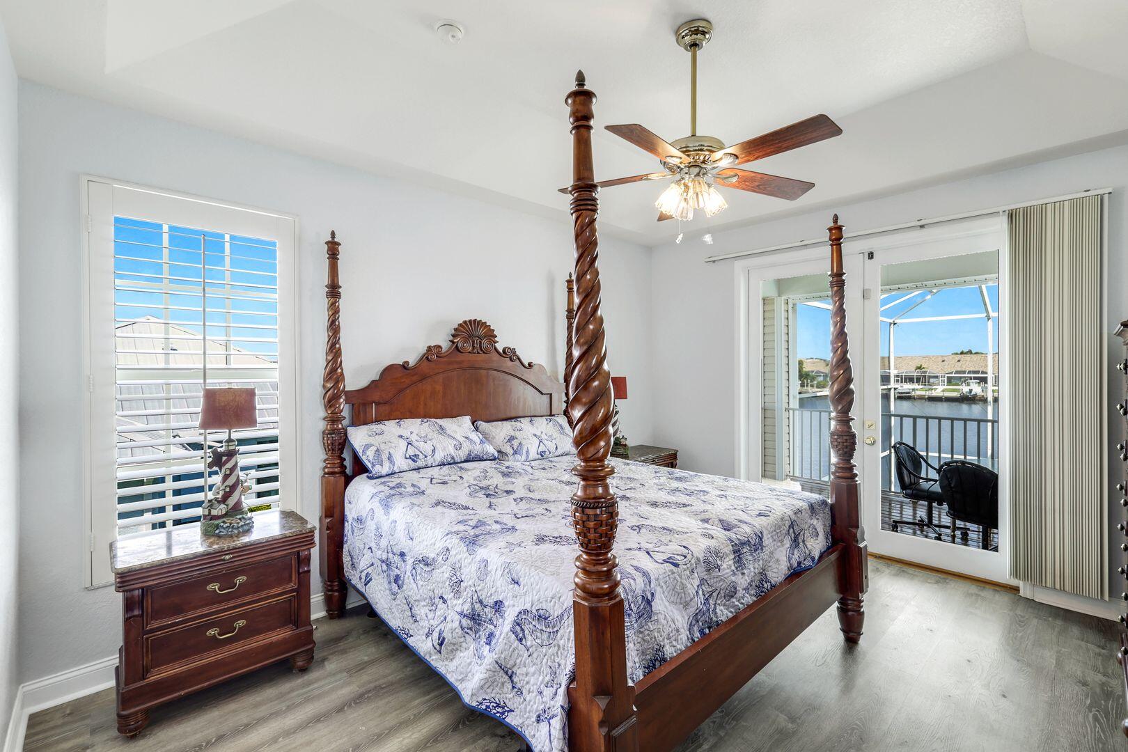 183 Sunset Cay Naples, FL 34114 - Photo 19 of 45 a bedroom with a bed and a chandelier