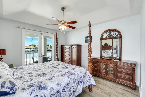a bedroom with a bed and a dresser with mirror