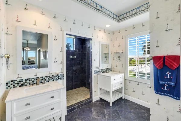 a spacious bathroom with a double vanity sink and a mirror