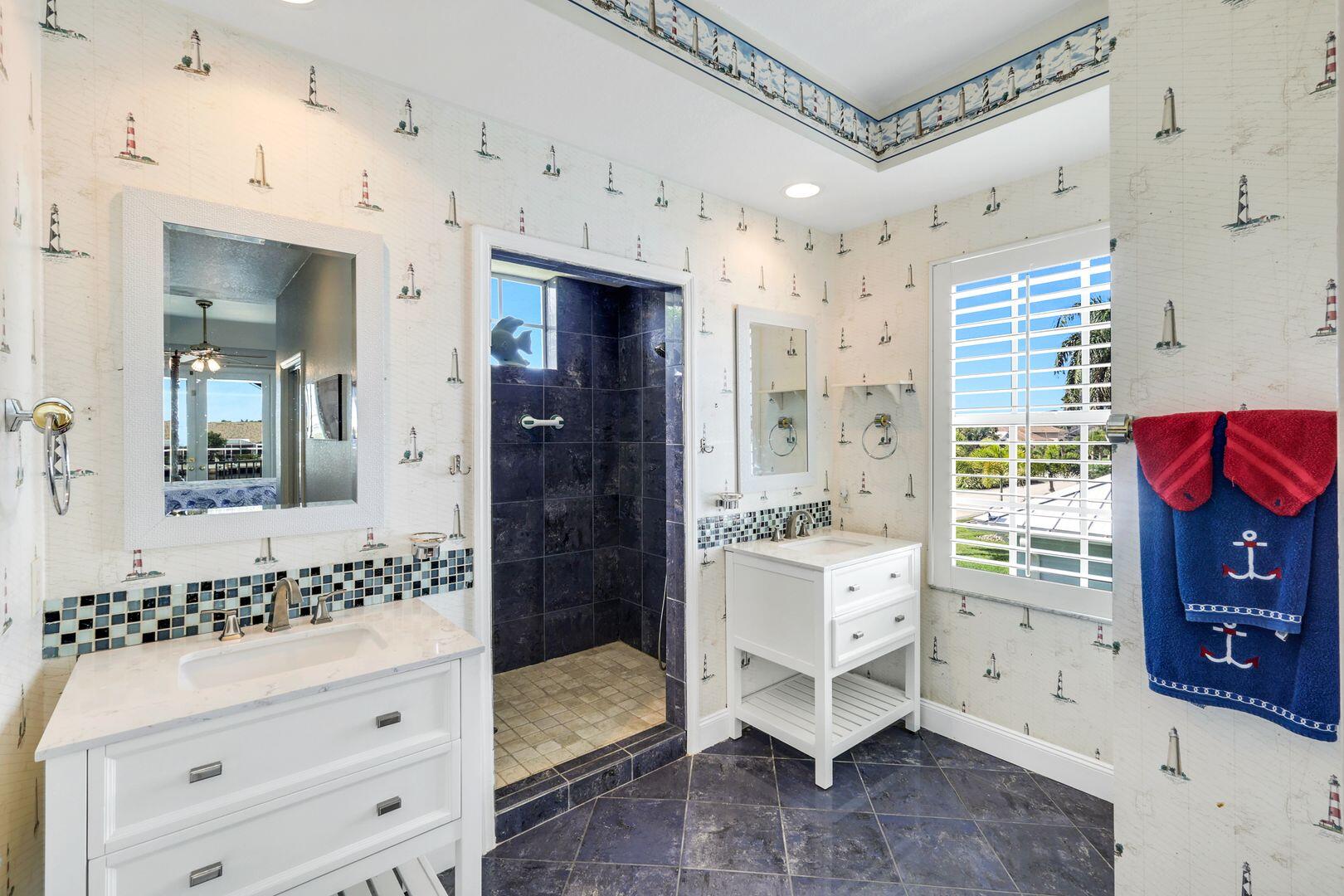 183 Sunset Cay Naples, FL 34114 - Photo 21 of 45 a spacious bathroom with a double vanity sink and a mirror