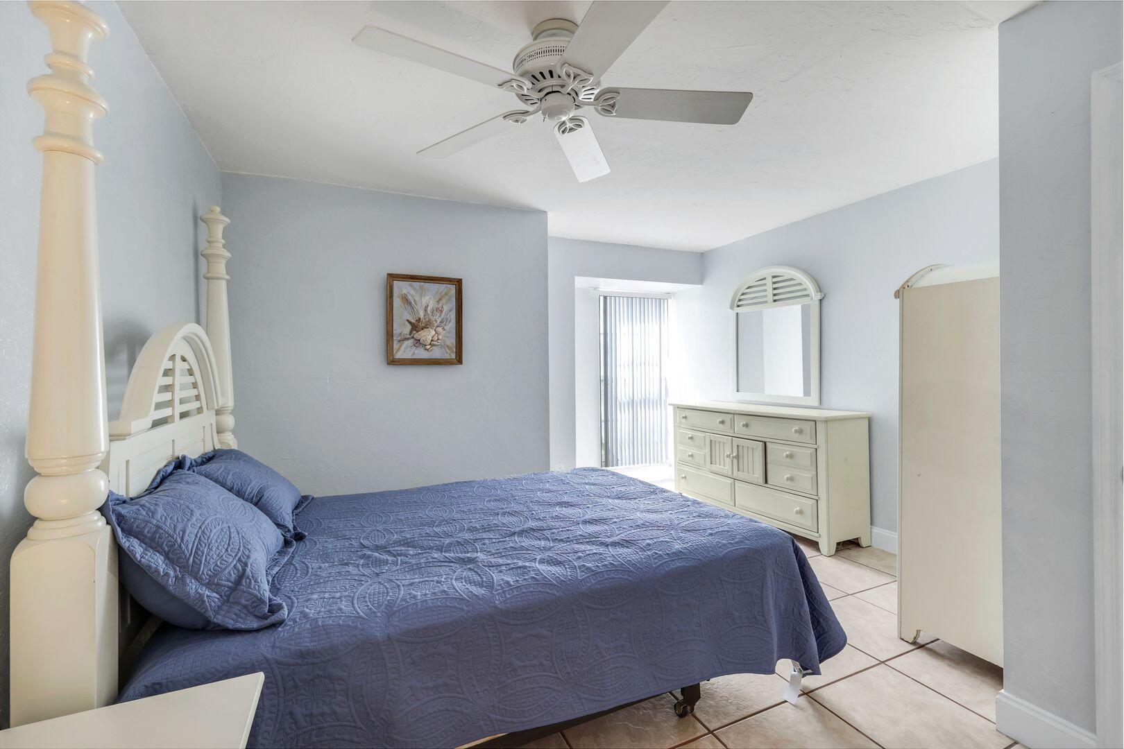 183 Sunset Cay Naples, FL 34114 - Photo 27 of 45 a bedroom with a large bed and a chandelier