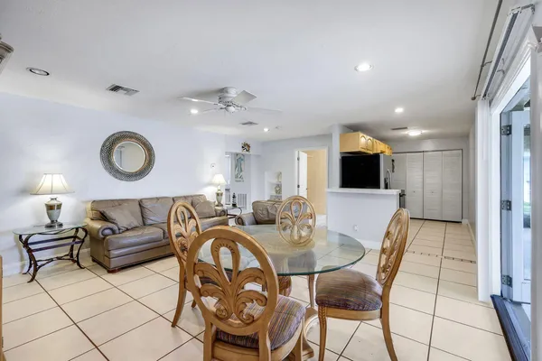 a living room with furniture a mirror and a flat screen tv