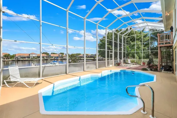 a view of a swimming pool with outdoor seating