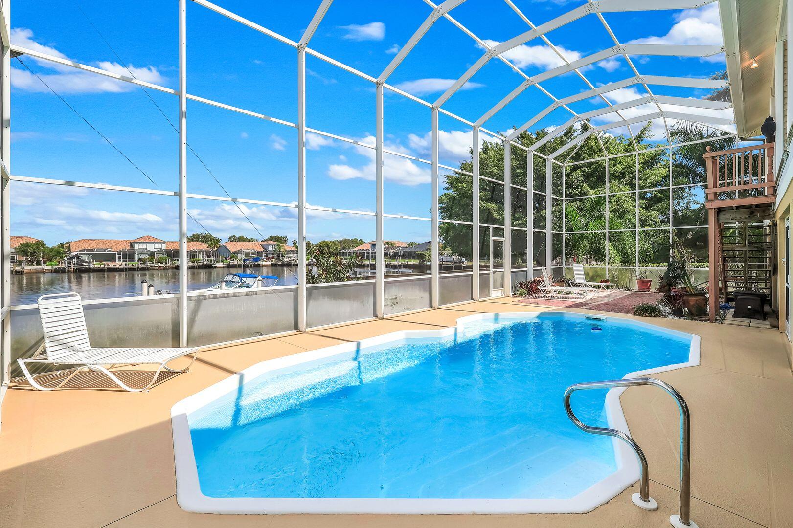 183 Sunset Cay Naples, FL 34114 - Photo 3 of 45 a view of a swimming pool with outdoor seating
