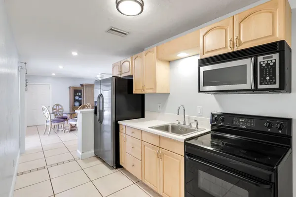 a kitchen with a sink appliances and cabinets