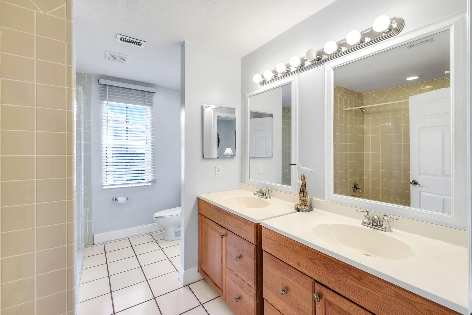183 Sunset Cay Naples, FL 34114 - Photo 32 of 45 a spacious bathroom with a double vanity sink a mirror and a shower