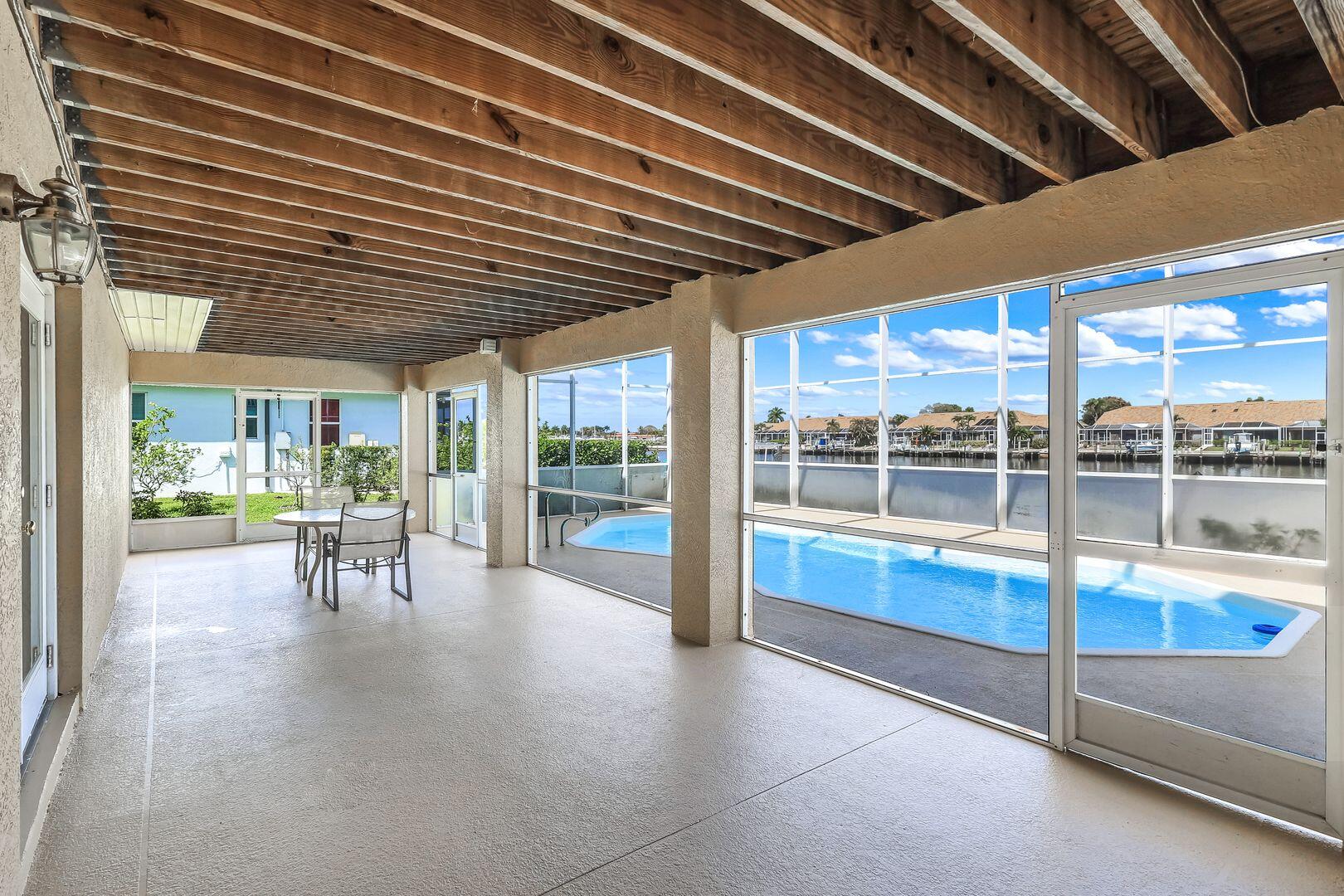 183 Sunset Cay Naples, FL 34114 - Photo 35 of 45 a view of a porch with chairs and backyard