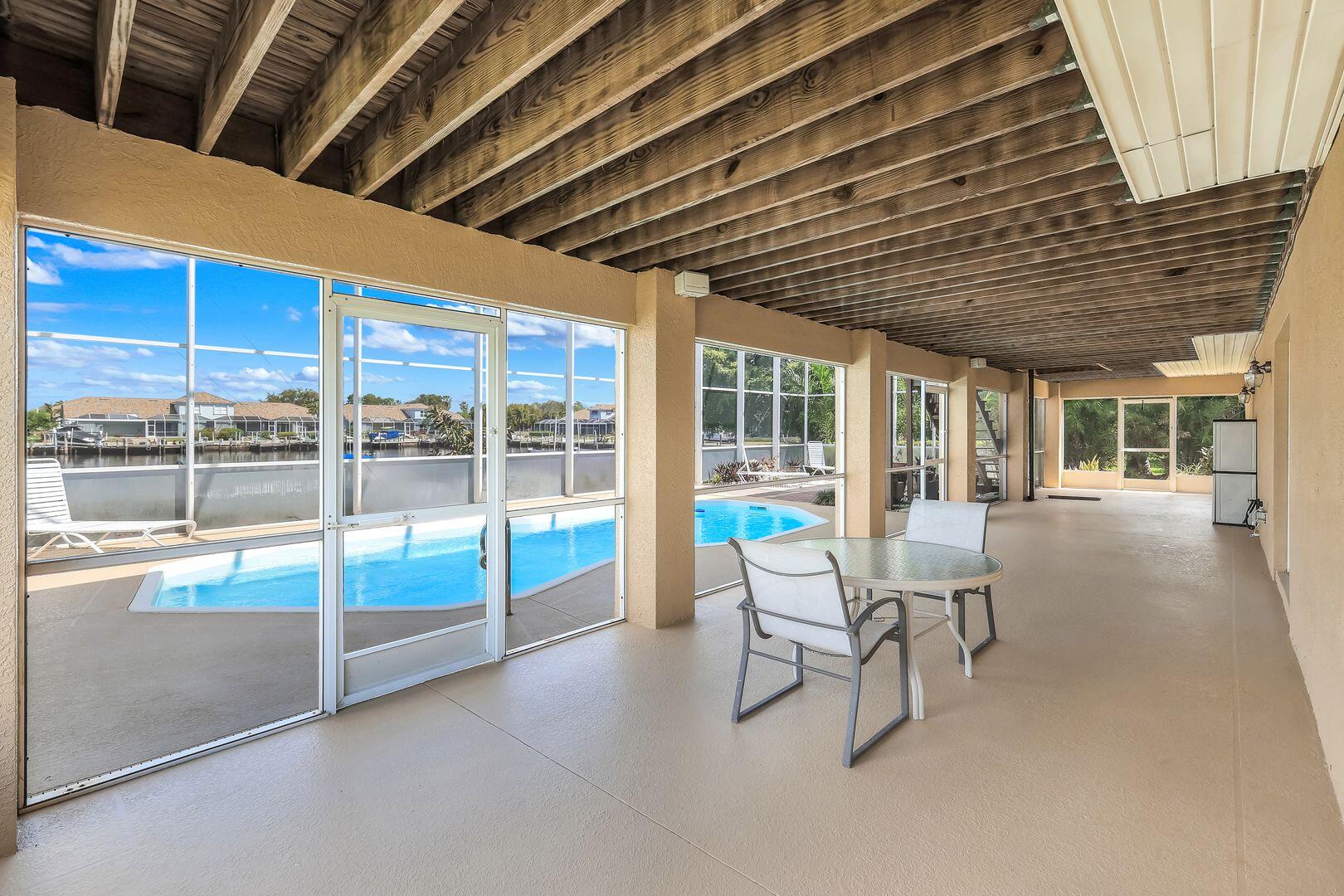 183 Sunset Cay Naples, FL 34114 - Photo 36 of 45 a dining room with furniture and floor to ceiling window
