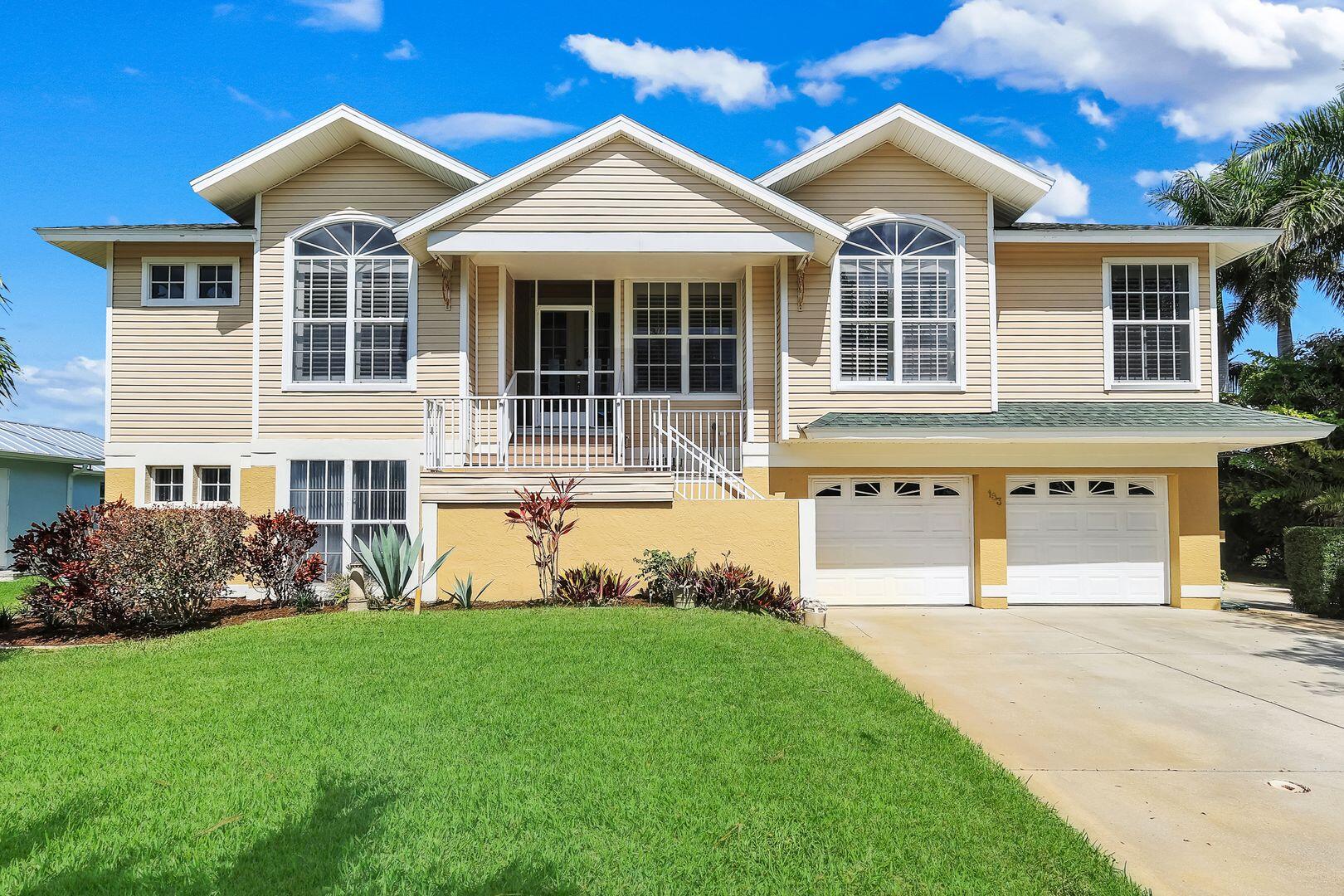 183 Sunset Cay Naples, FL 34114 - Photo 44 of 45 a front view of a house with a yard and porch
