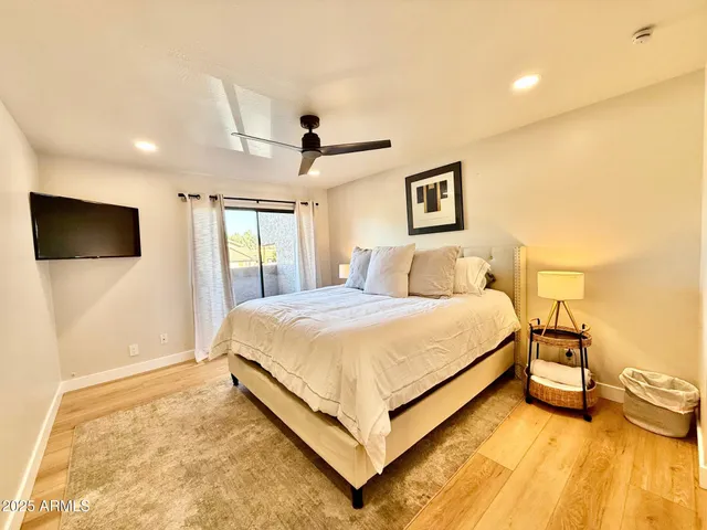 a bathroom with a granite countertop sink mirror vanity and toilet