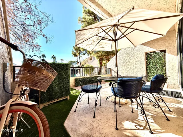 a view of a backyard with sitting area