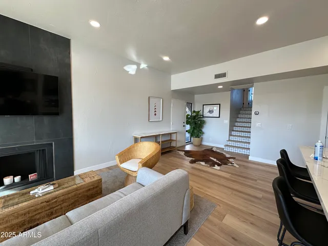 a living room with furniture and a fireplace