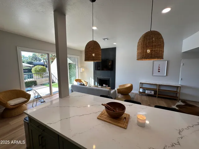 a large kitchen with stainless steel appliances kitchen island granite countertop a sink counter space and cabinets