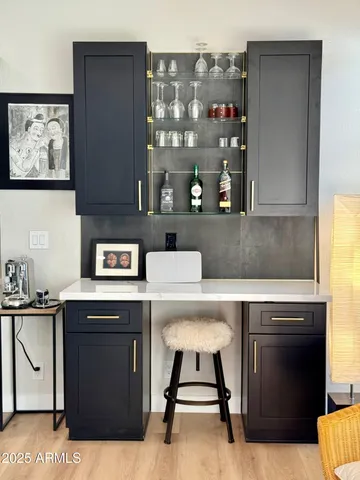 a view of a kitchen area with furniture and wooden floor