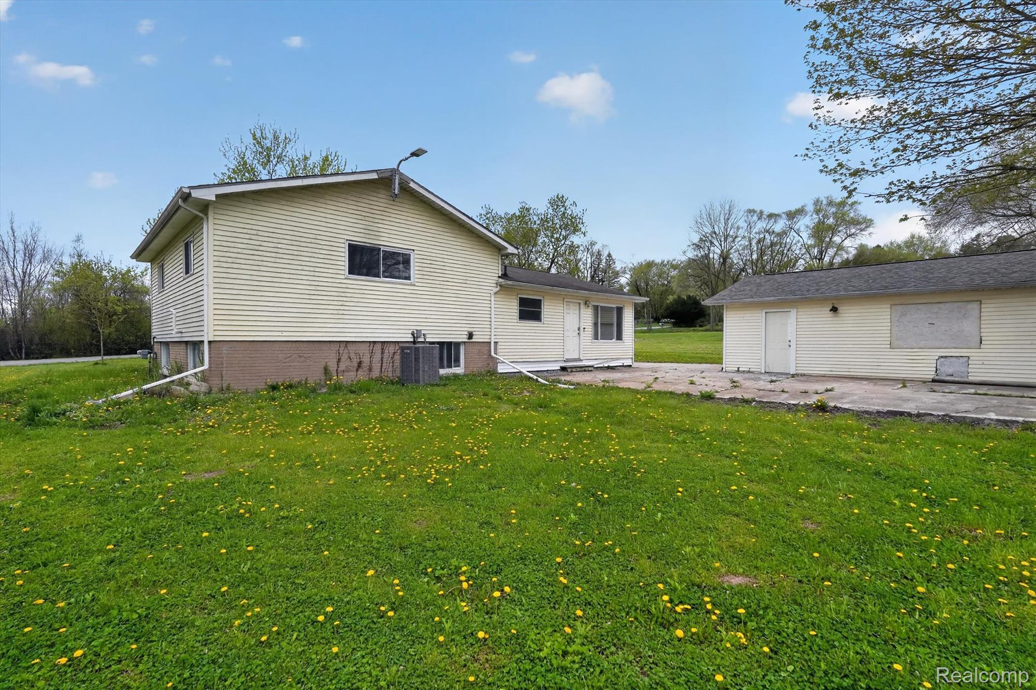 5457 East Frances Road Mount Morris, MI 48458 - Photo 36 of 42 Back of house featuring a lawn