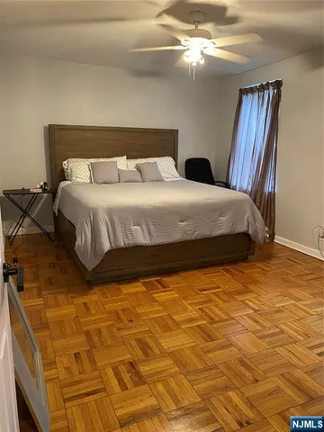 a large bed sitting in a bedroom next to a window