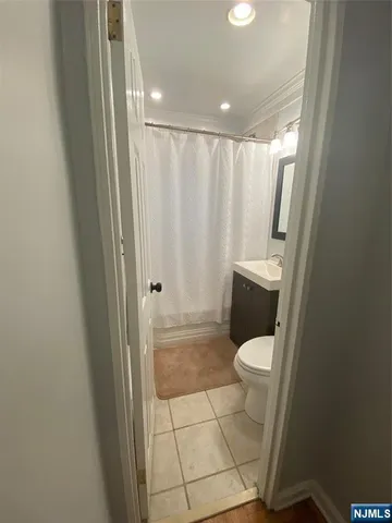 a white toilet sitting in a bathroom next to a sink