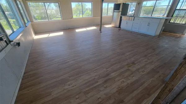 a view of outdoor space with wooden floor and windows