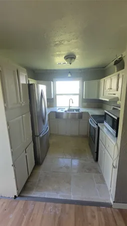 a kitchen with stainless steel appliances granite countertop a refrigerator stove a sink and dishwasher